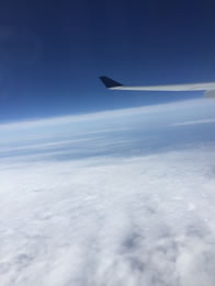 Photo through airline window of clouds