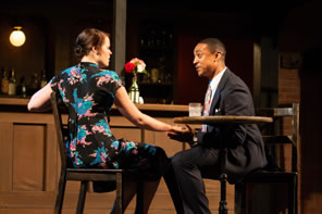 Photo of Kate and Petruchio sitting at a table in a bar