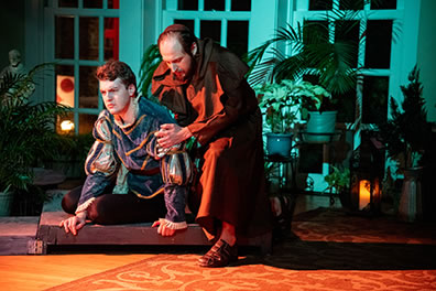 Production photo of Romeo on the ground and Friar Laurence comforitng him. Photo by Kenneth Garrett