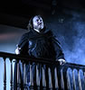 Production photo by Kenneth Garrett of Hamlet standing on the balcony with fog rising around him. 