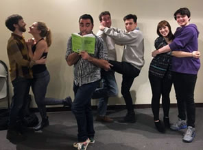 The cast paired off and clowning in a rehearsal room