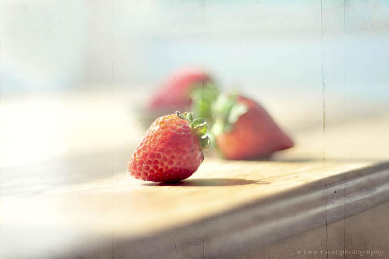 Strawberries on windowwsill in deep forcus