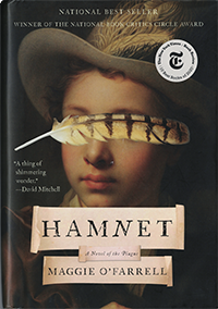 The book cover of "Hamnet, Anovel of the Plague, Maggie O'Farrell with a picture of a boy wearing a feathered hat and a brown striped feather across his eyes. "National Best Seller," "Winner of the National Book Critics Circle Award," "A thing of shimmering wonder."--David Mitchell, and a seal of The New York Times Book Review 10 Best Books of 2020"