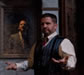 Richard in vest with hands out signing and in the mirror behind him Shadow in a suit